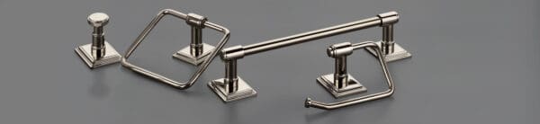 A set of three bathroom accessories in brushed nickel.