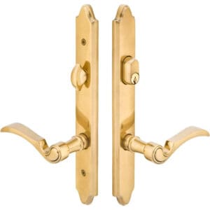 A pair of gold door handles with a key hole.