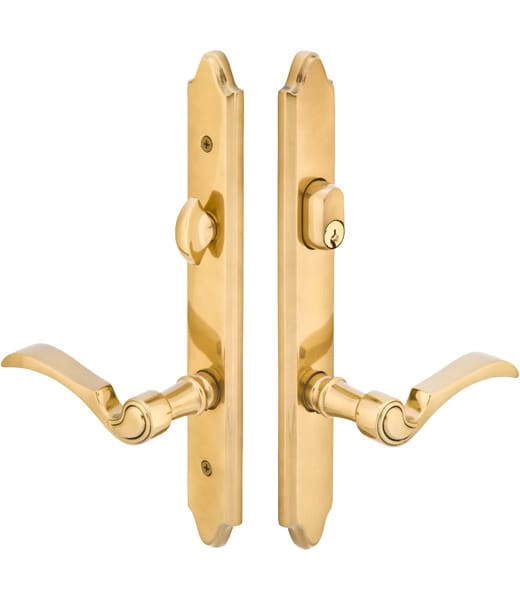 A pair of gold door handles with a key hole.