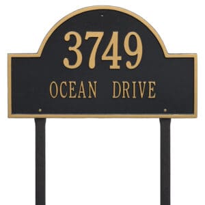 A black and gold sign with the number 3 7 4 9 on it.