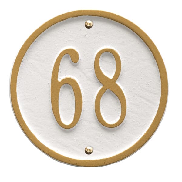 A white and gold house number plaque with the numbers 6 8.