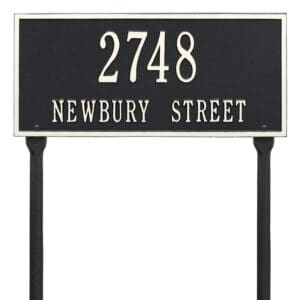 A black and white sign with numbers on it