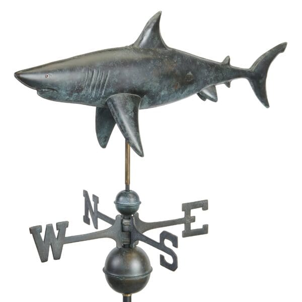 A metal shark weathervane with a weather vane.