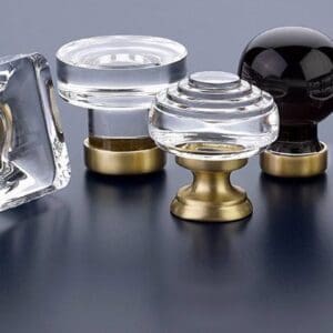 A group of four glass knobs on top of a table.