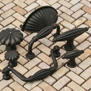 A set of four black knobs and handles on the ground.